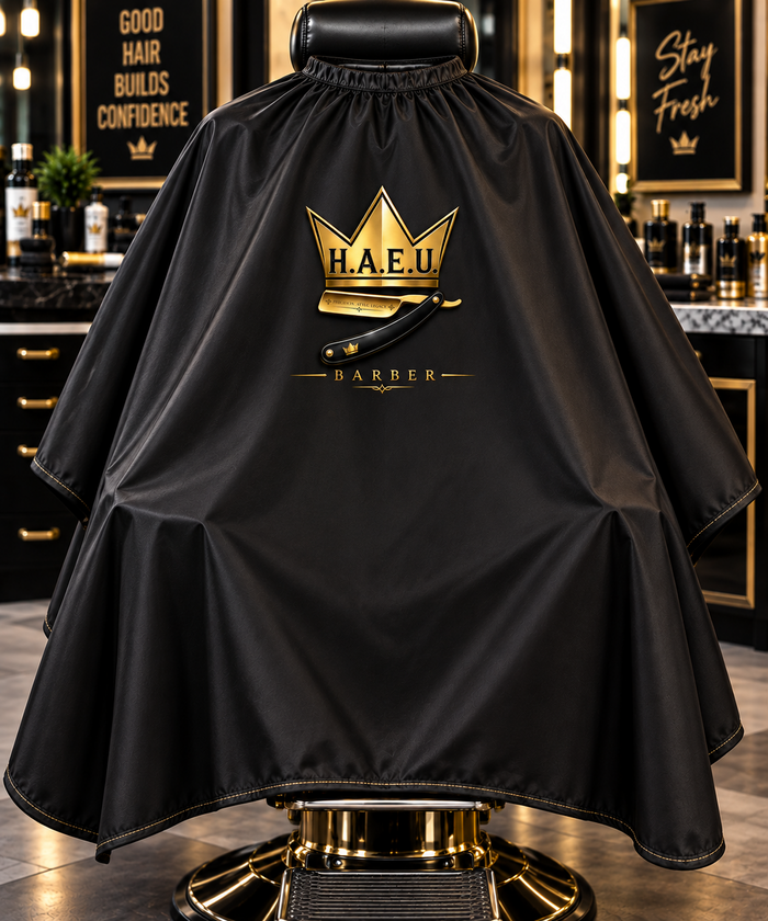Black H.A.E.U. Barber cape with gold logo